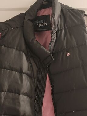 Women's Black Puffer Vest with Pink Lining.